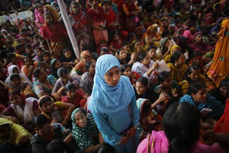 Garment workers listen to speakers during a rally demanding an increase to their minimum wage in Dhaka